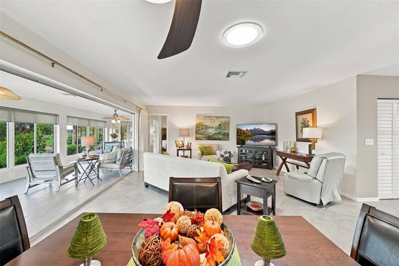 211 STONEHAM DRIVE, Sun City Center, FL 33573 Multiple sliding glass doors offer a separation of space, if desired.
