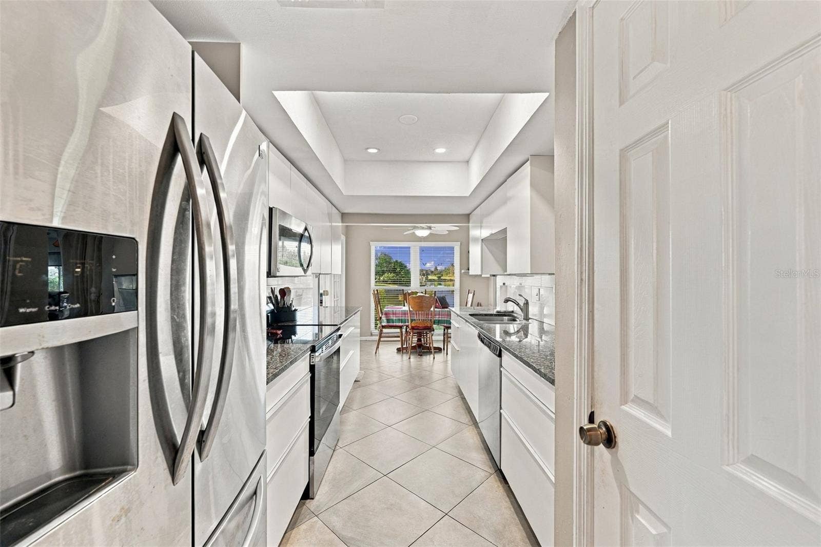 211 STONEHAM DRIVE, Sun City Center, FL 33573 Kitchen offers lovely stainless steel appliances, lots of storage (including a pantry), granite counter tops and an exceptional view.