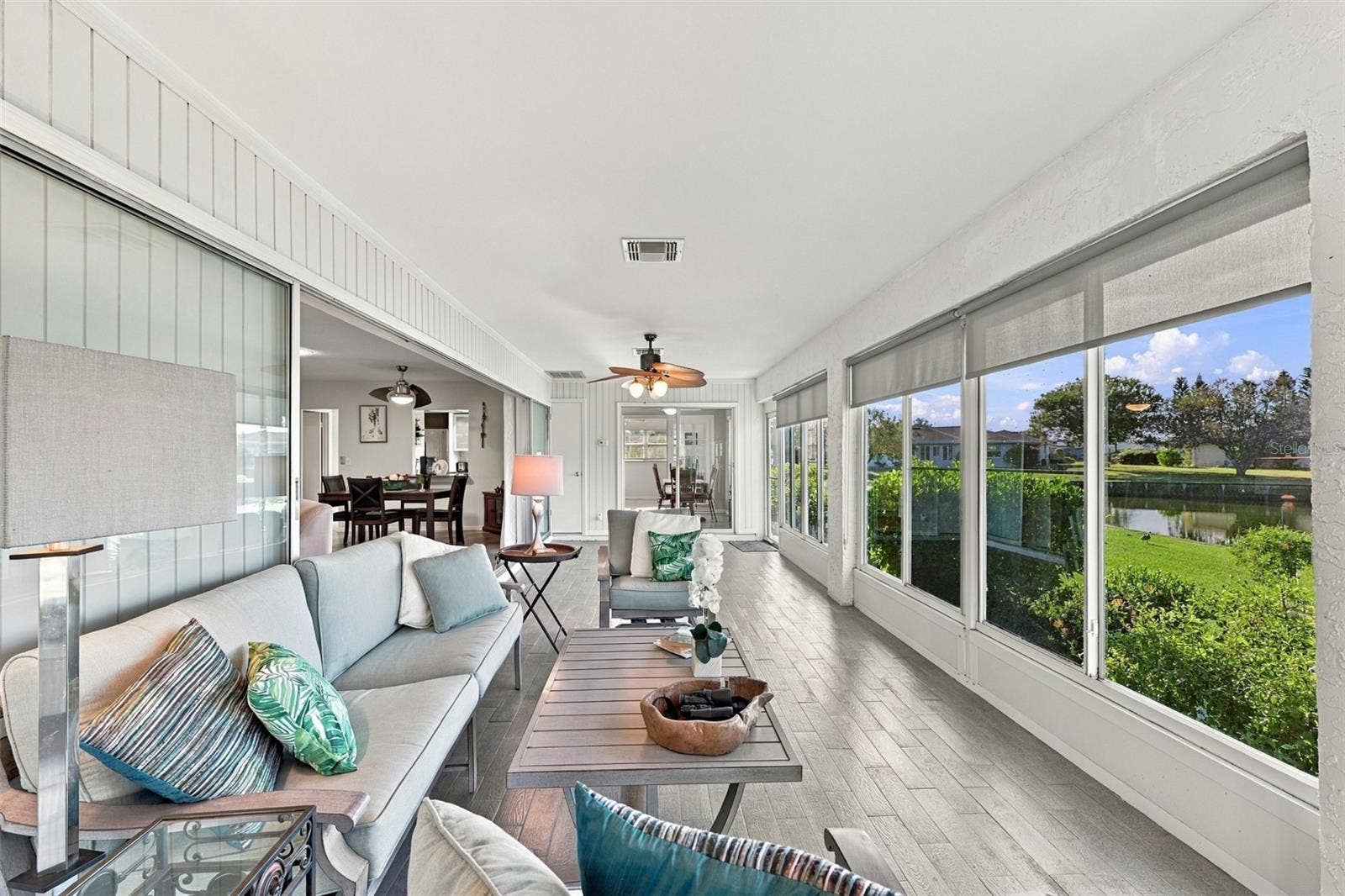 211 STONEHAM DRIVE, Sun City Center, FL 33573 The perfect place to watch the world go by, read a book or just take a nap! Notice how the sliding glass doors all go behind the wall for maximum opening space.