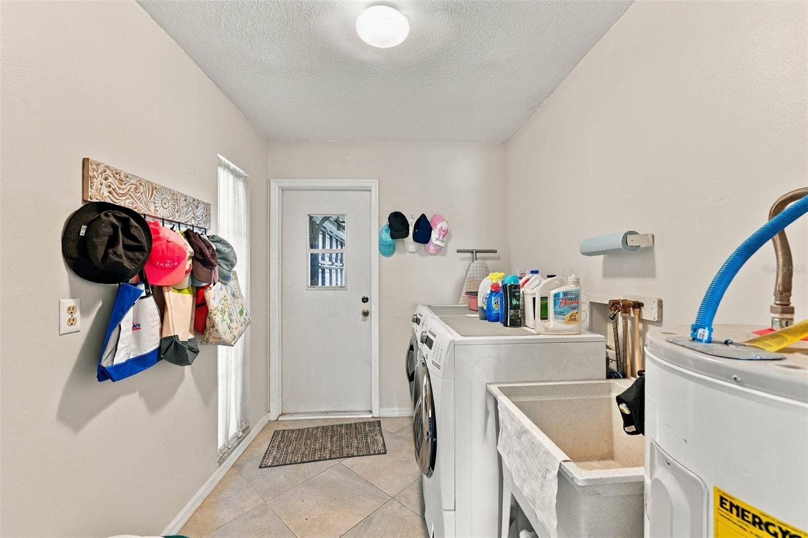 211 STONEHAM DRIVE, Sun City Center, FL 33573 Laundry room is large with easy access to the garage.