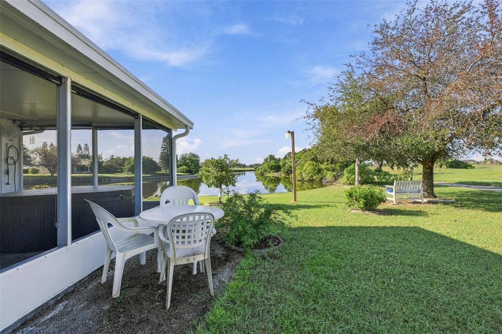 211 STONEHAM DRIVE, Sun City Center, FL 33573 The green space is incredible with an outside bench and light to enjoy this premium lot.