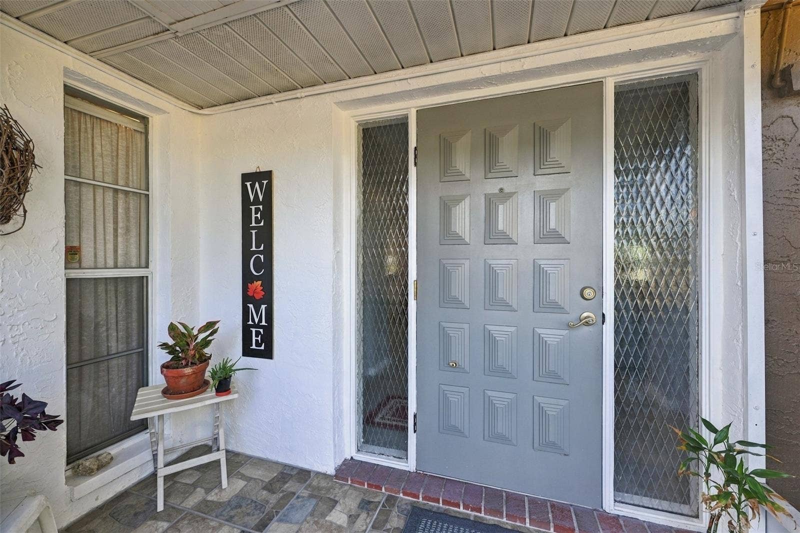 211 STONEHAM DRIVE, Sun City Center, FL 33573 Screened front porch is and excellent area for plants and guests to get out of the weather.