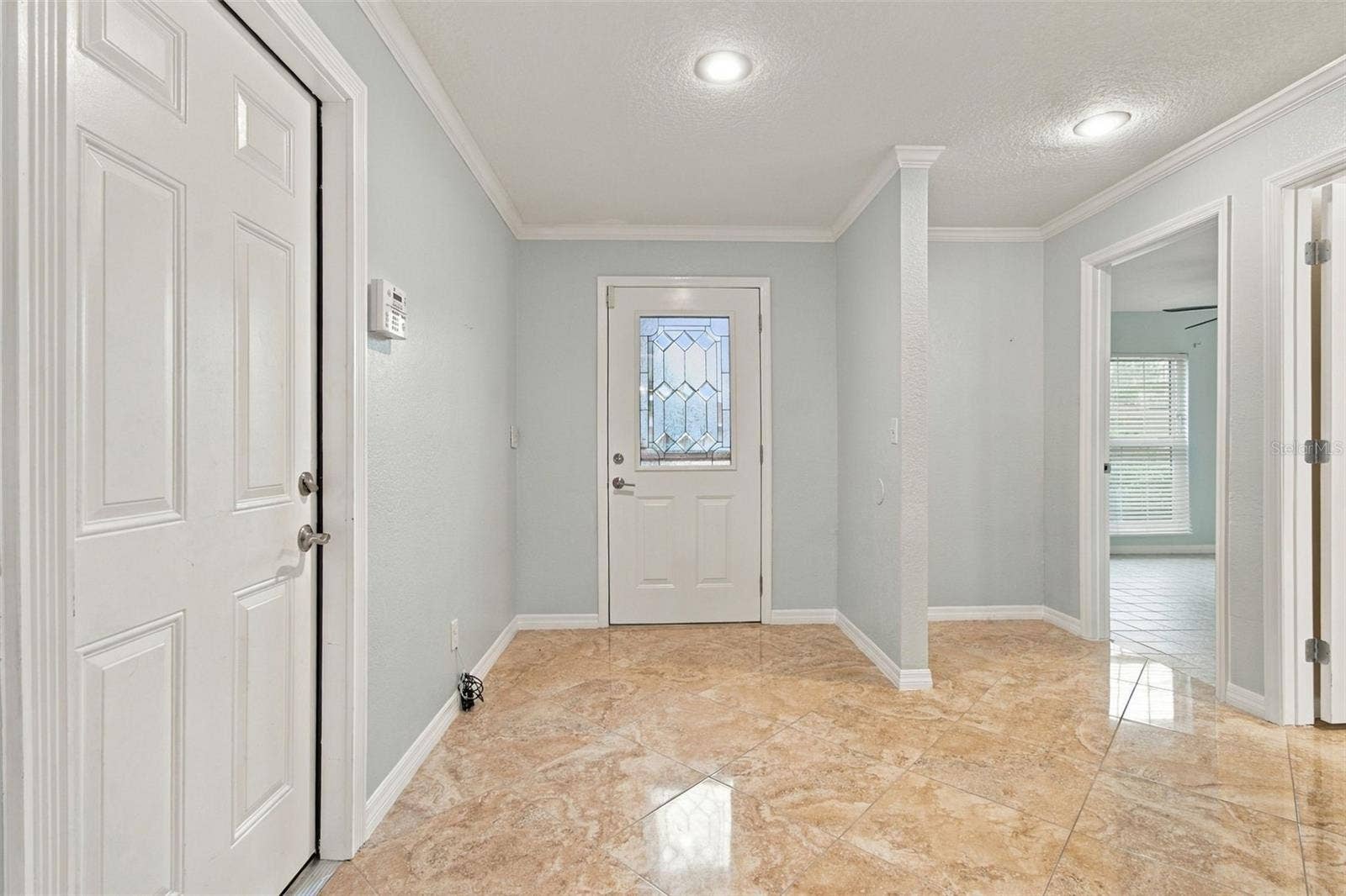 2254 HERON CIR, Clearwater, FL 33762 The foyer is spacious for entry furniture. The wall keeps the front bedroom private from the entry.