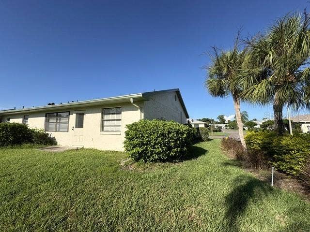 2102 HARRINGAY STREET, #449, Sun City Center, FL 33573 Back of home, pretty Florida landscaping features on this corner lot.