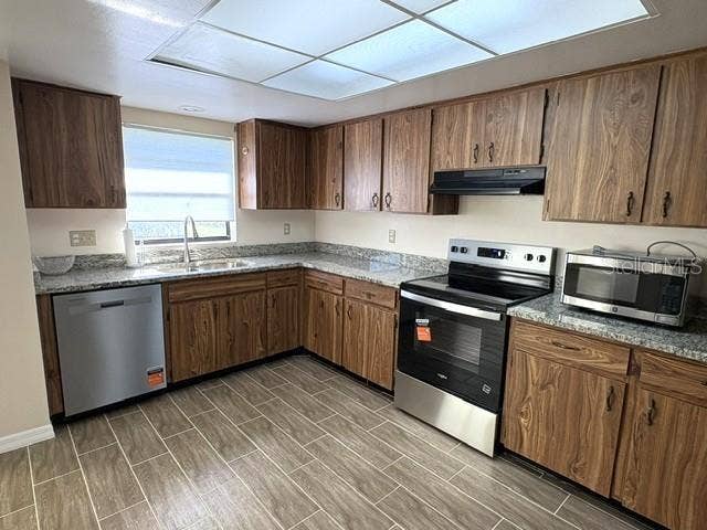 2102 HARRINGAY STREET, #449, Sun City Center, FL 33573 Kitchen is updated with beautiful stainless appliances, ceramic tile flooring and granite countertops.