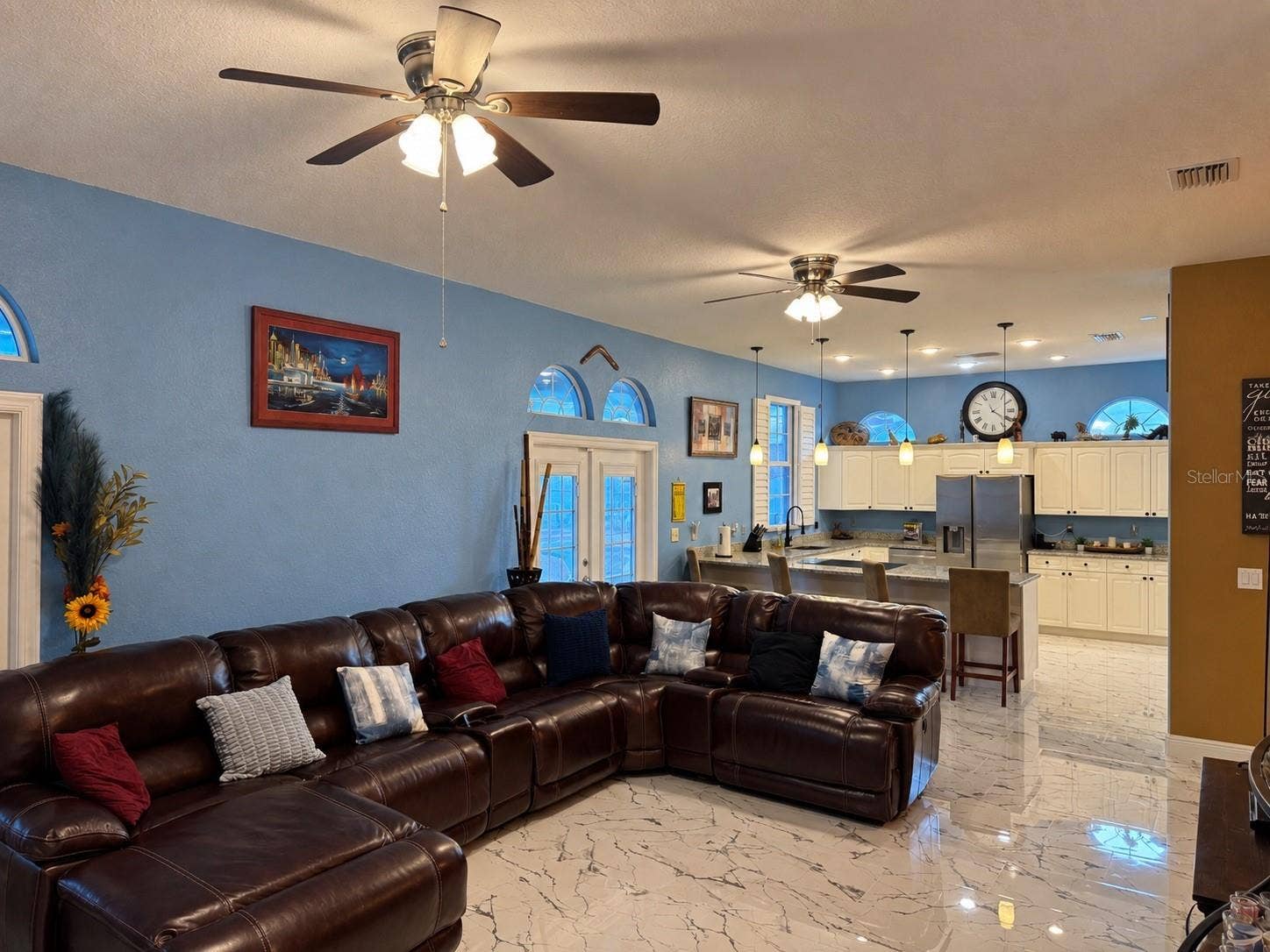 3009 W CLINTON STREET, Tampa, FL 33614 Large living room with view to kitchen and access to backyard through French doors