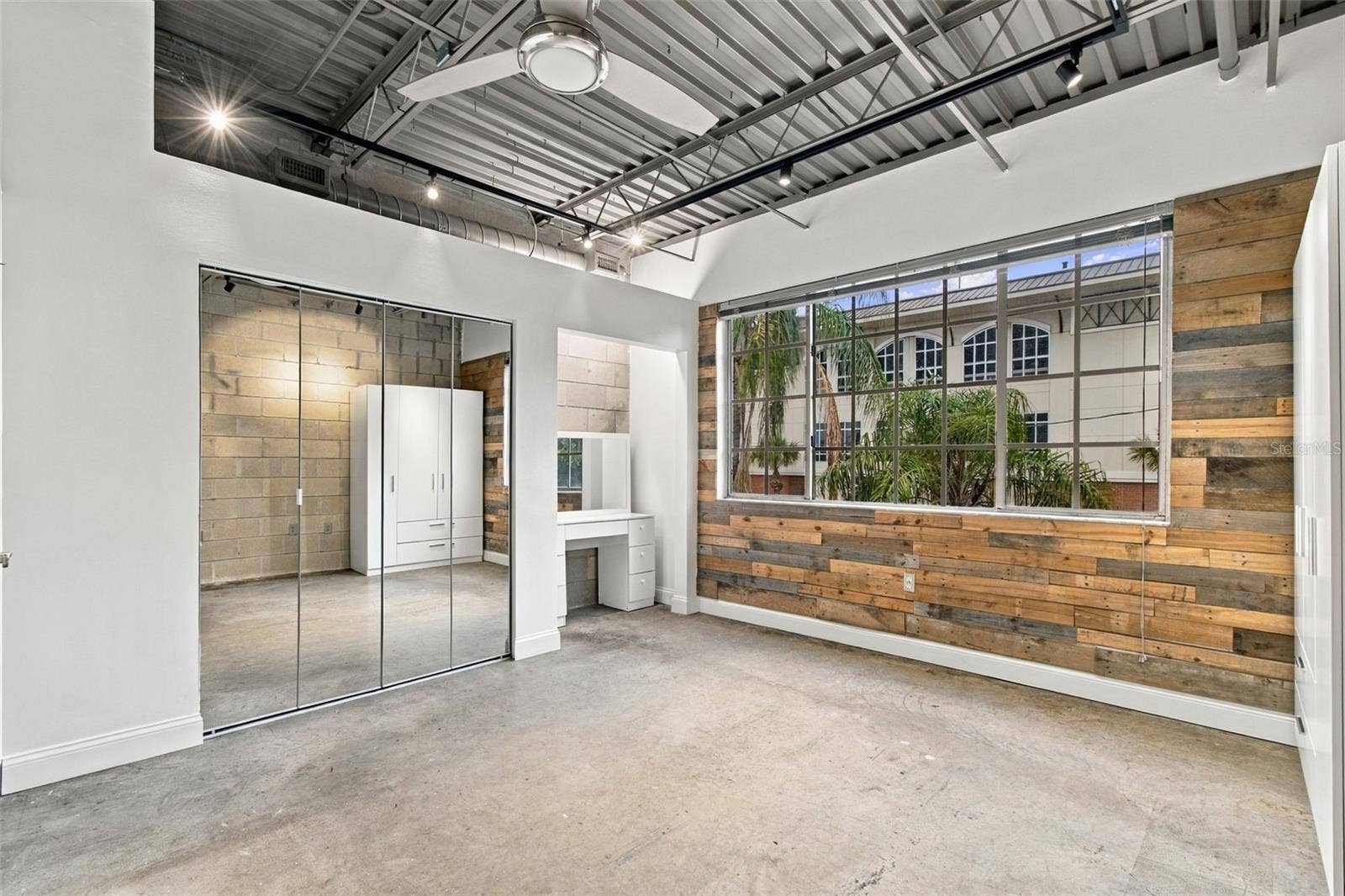 2509 W AZEELE STREET, Tampa, FL 33609 Primary bedroom features textured wood-plank wall.