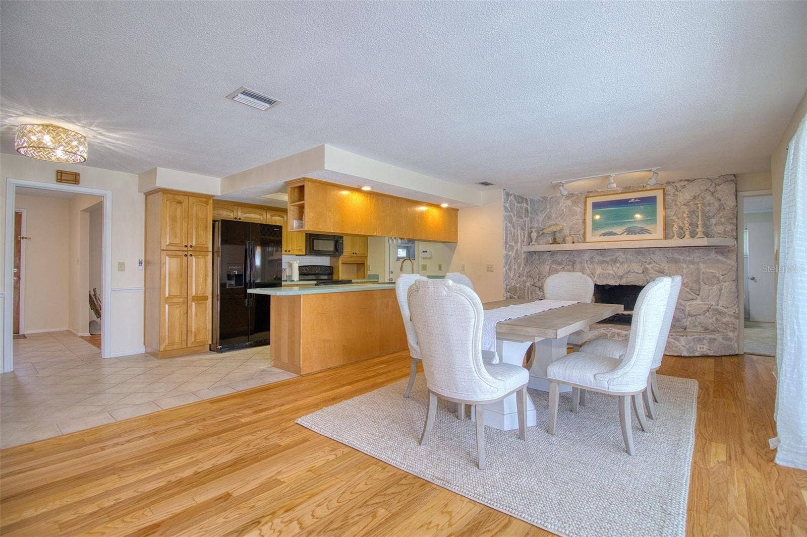 Great room with decorative fireplace and real wood floors