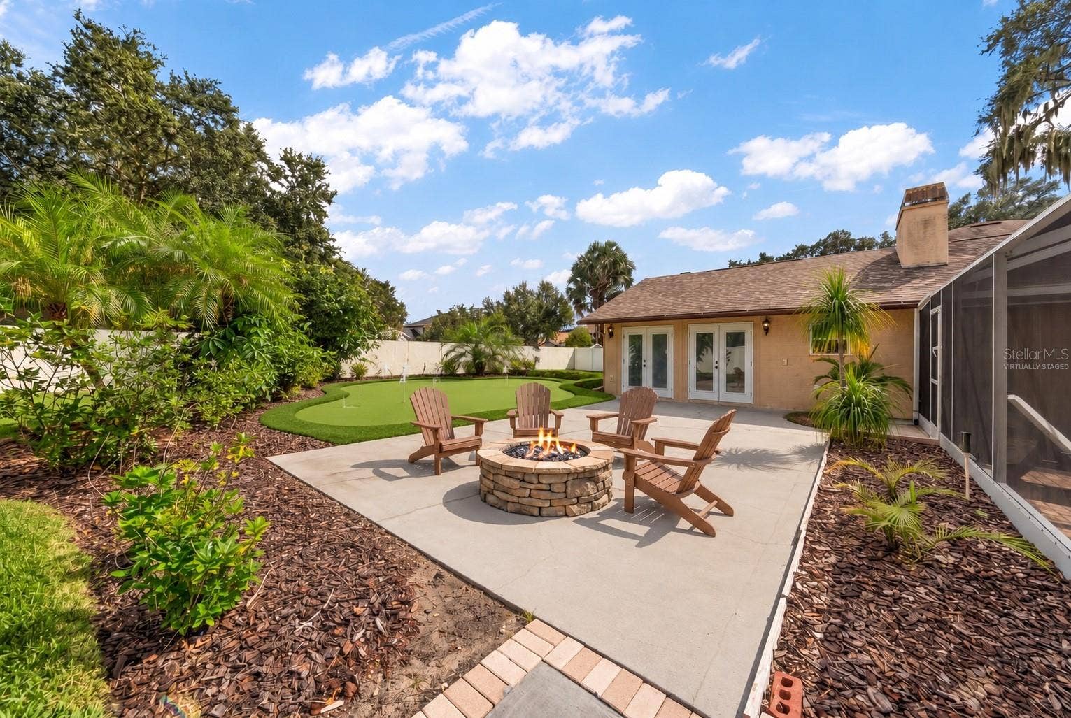 1105 DEER RUN PLACE, Valrico, FL 33594 Looking out from patio with virtually staged fire-pit and putting green.