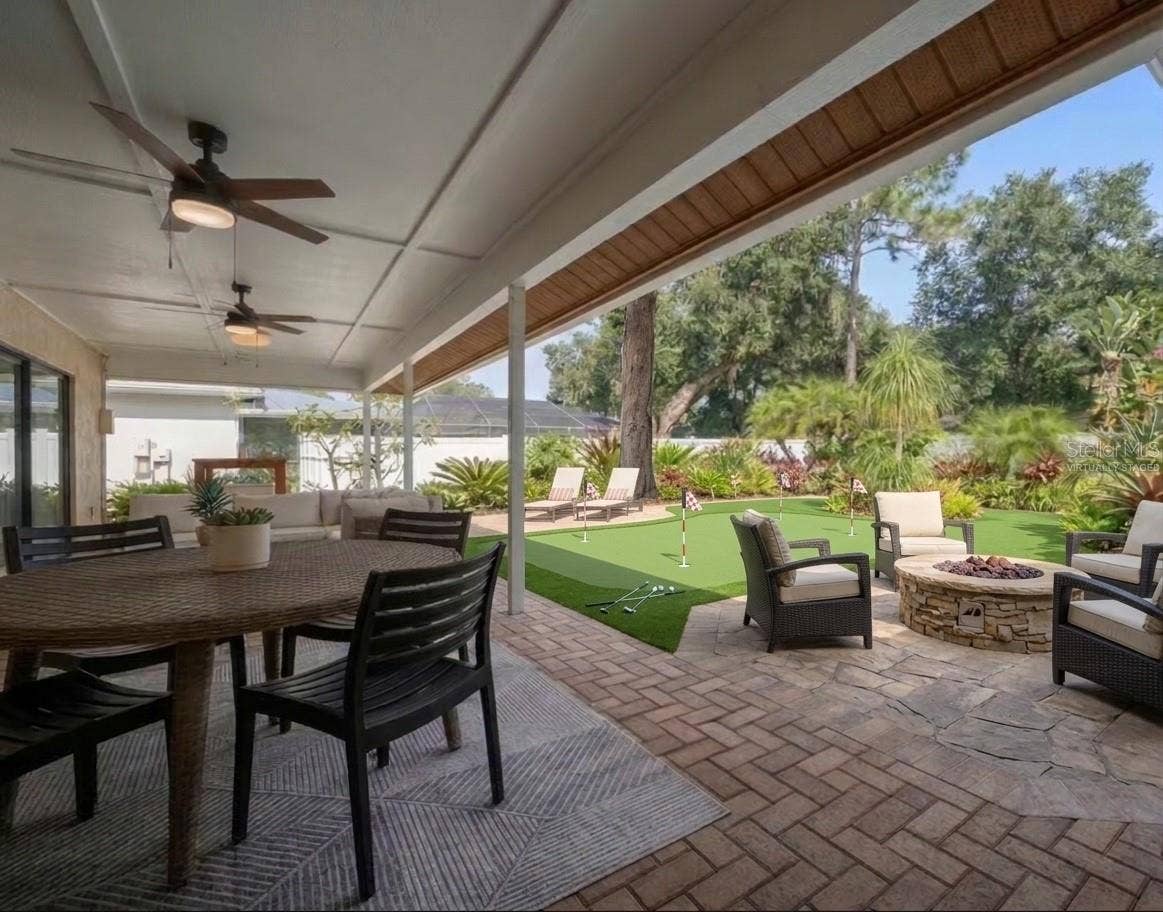 1105 DEER RUN PLACE, Valrico, FL 33594 Looking out from patio with virtually staged fire-pit and putting green.