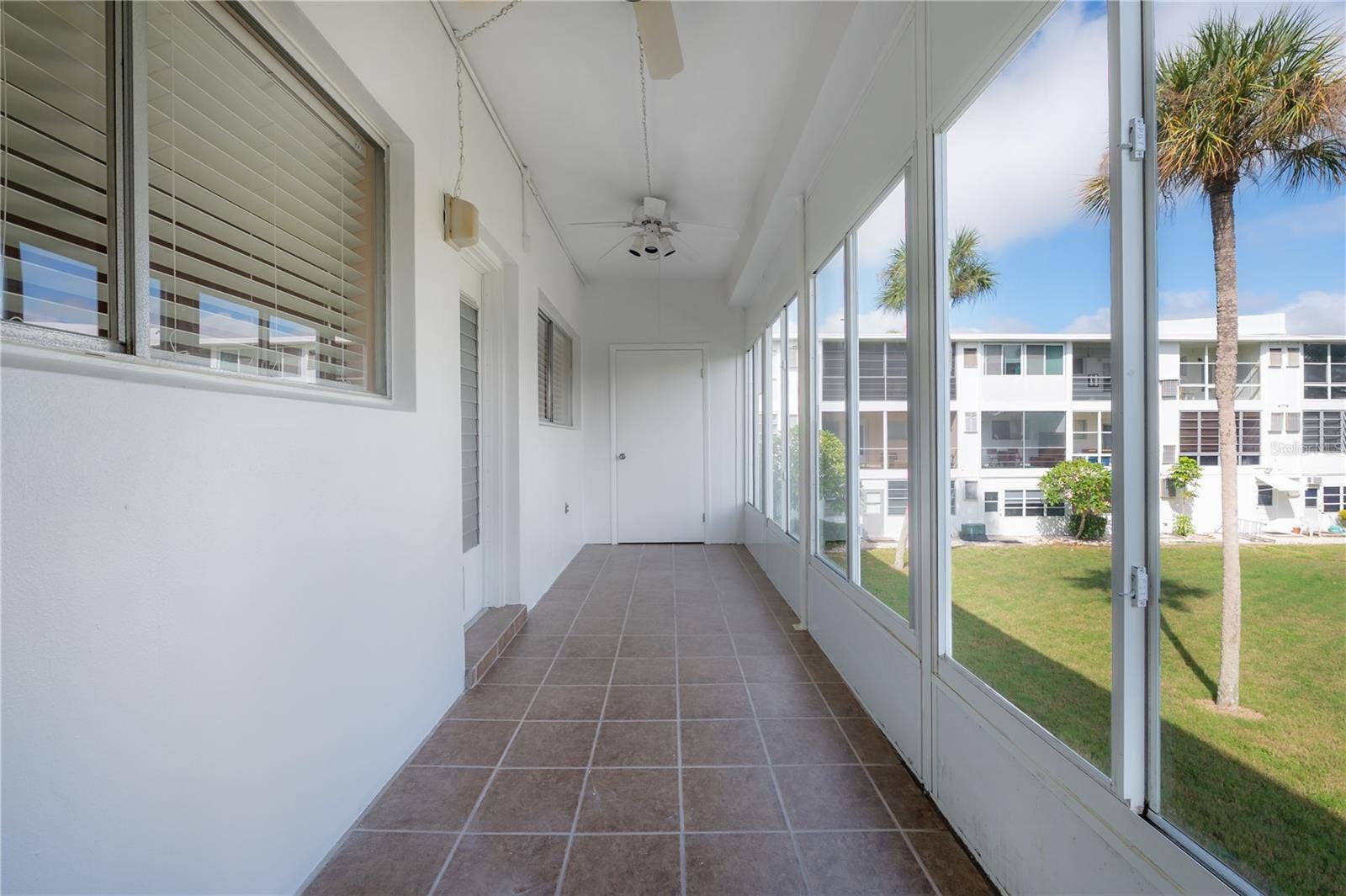 8055 112TH STREET, #205, Seminole, FL 33772 Lanai that runs the full width.