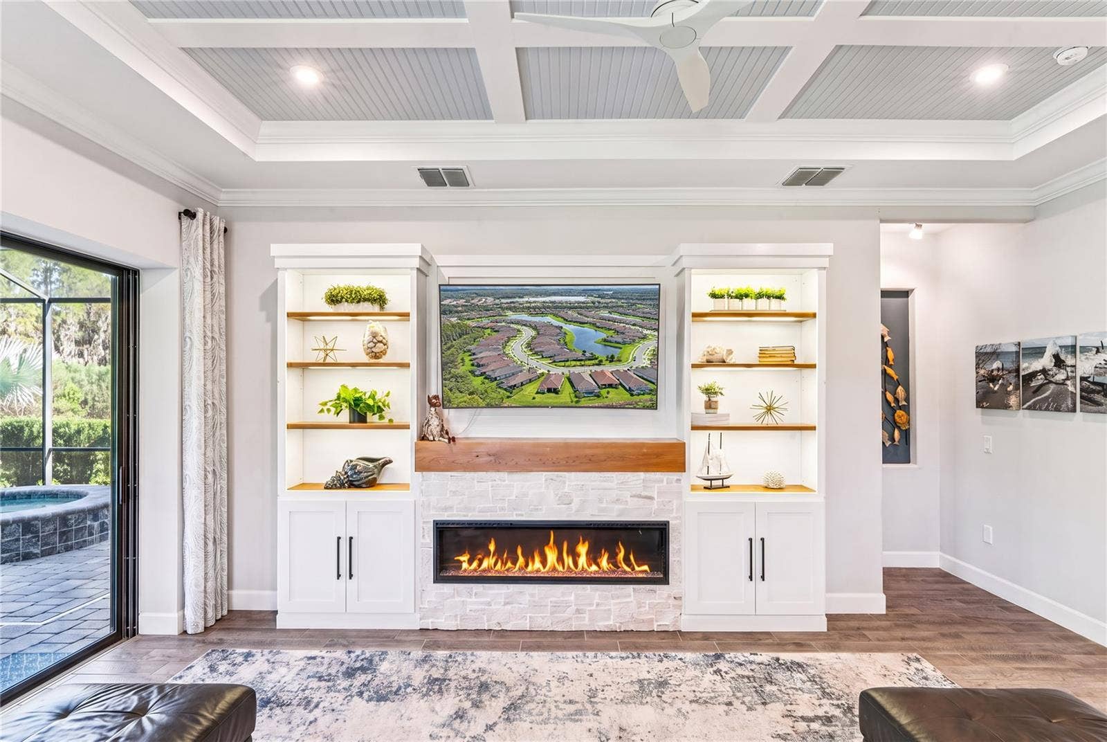Custom built TV wall with stone, wood shelves, and Fireplace