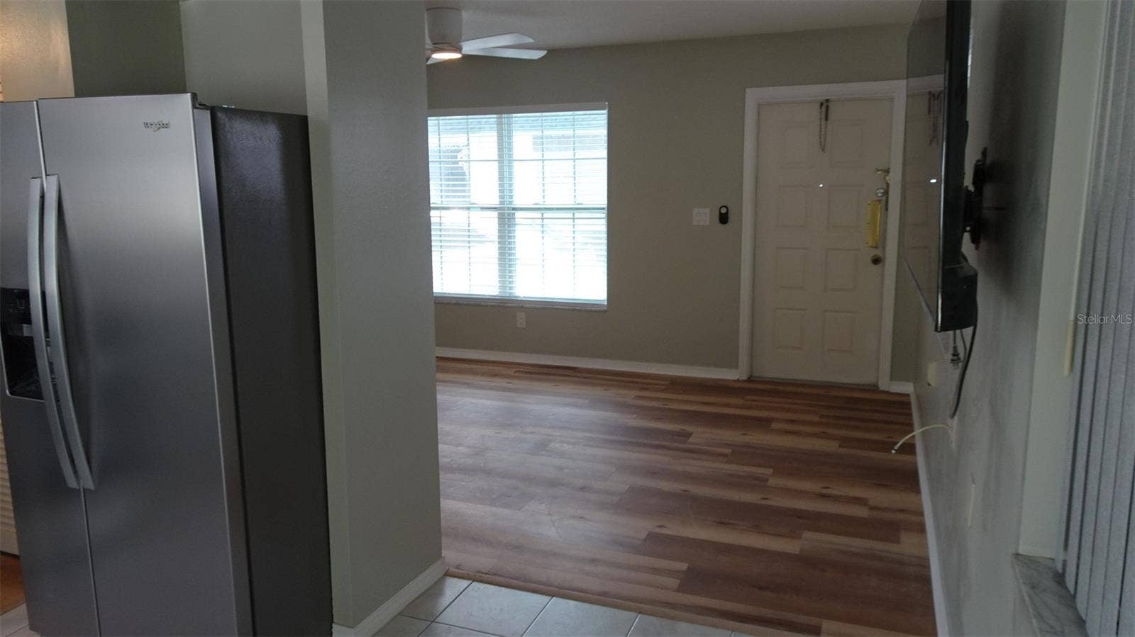 7809 38TH TERRACE N, St Petersburg, FL 33709 From dining area into living room.. Would you like the wall mounted TV to stay? Just ask.
