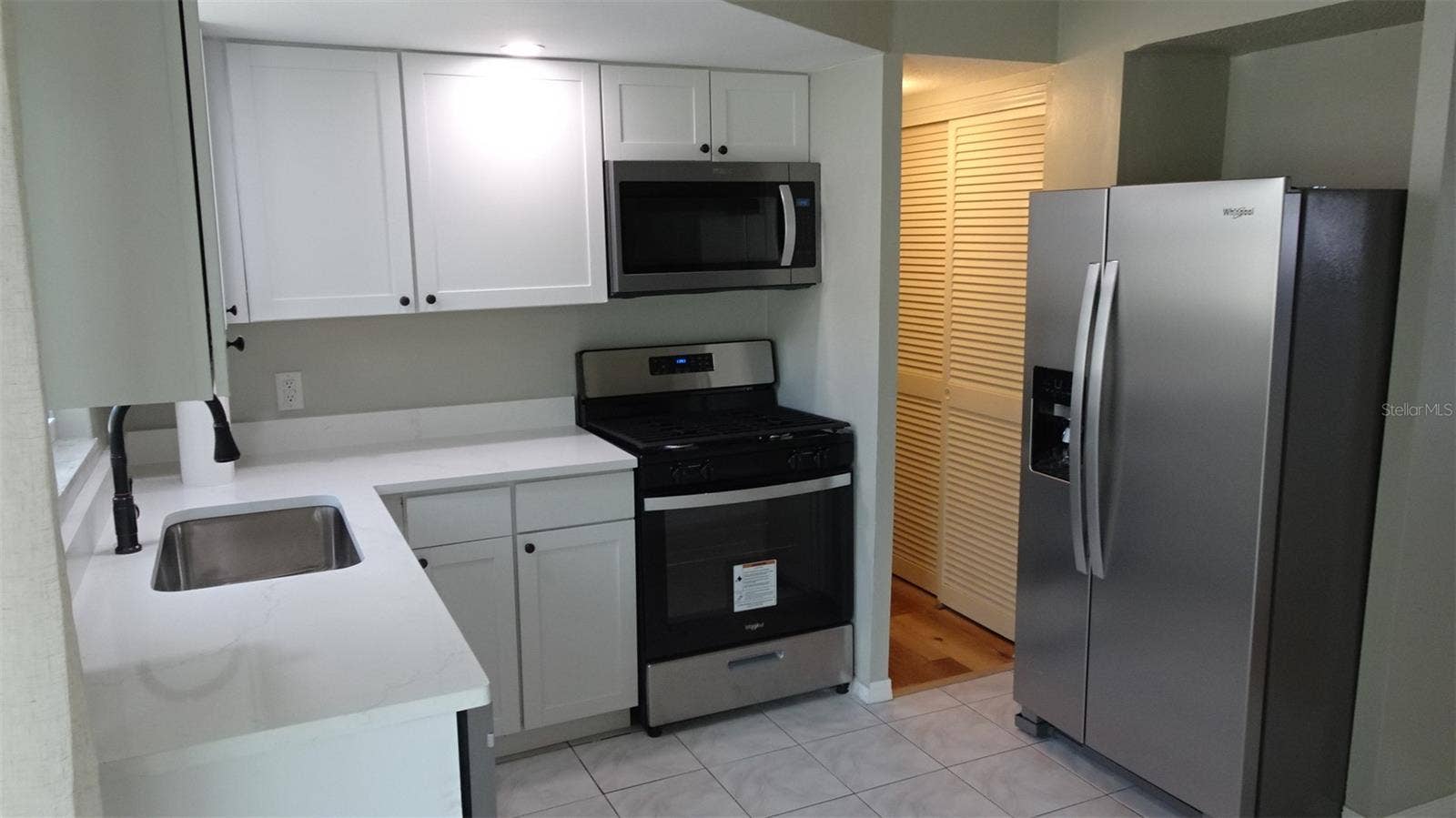 7809 38TH TERRACE N, St Petersburg, FL 33709 Natural gas stove. Pantry in the hallway.