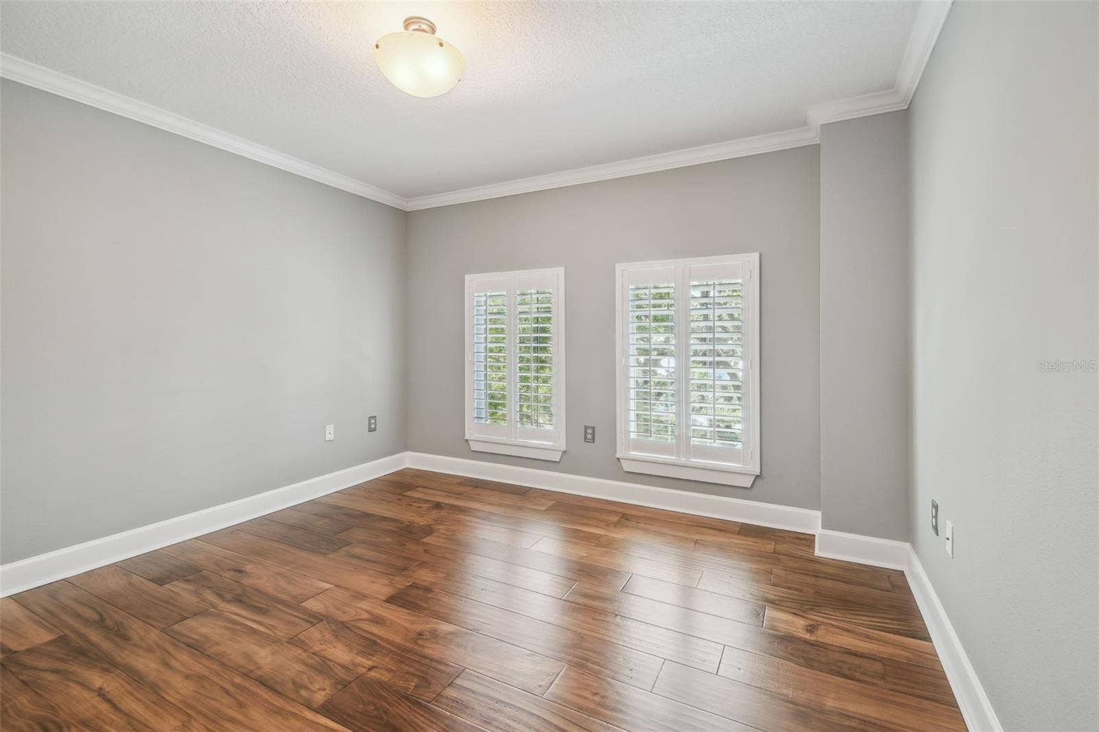 435 S OREGON AVENUE E, #304, Tampa, FL 33606 Guest bedroom, featuring hardwood floors and plantation shutters.