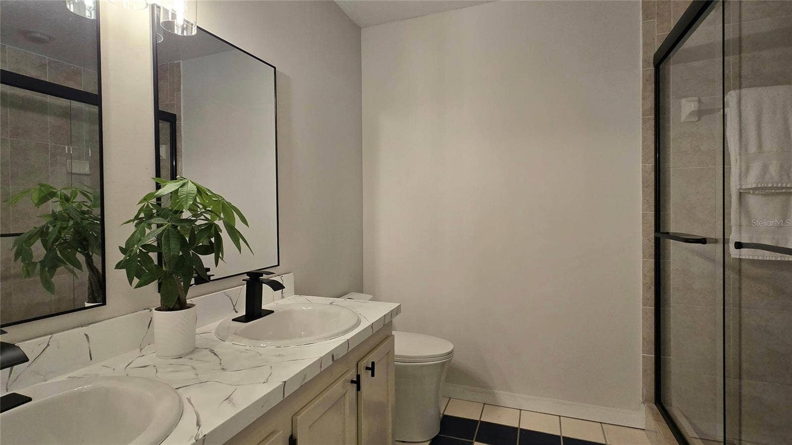 Primary Ensuite Bath with Double Vanity and Shower with new glass doors.