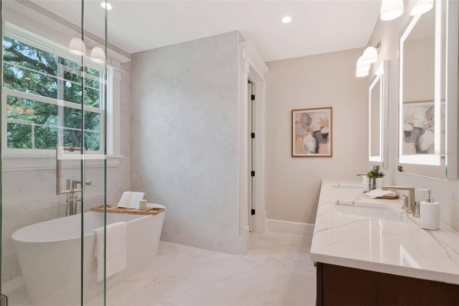 4706 W SAN JOSE STREET, Tampa, FL 33629 Dual vanities, glass shower, and tub in primary bath