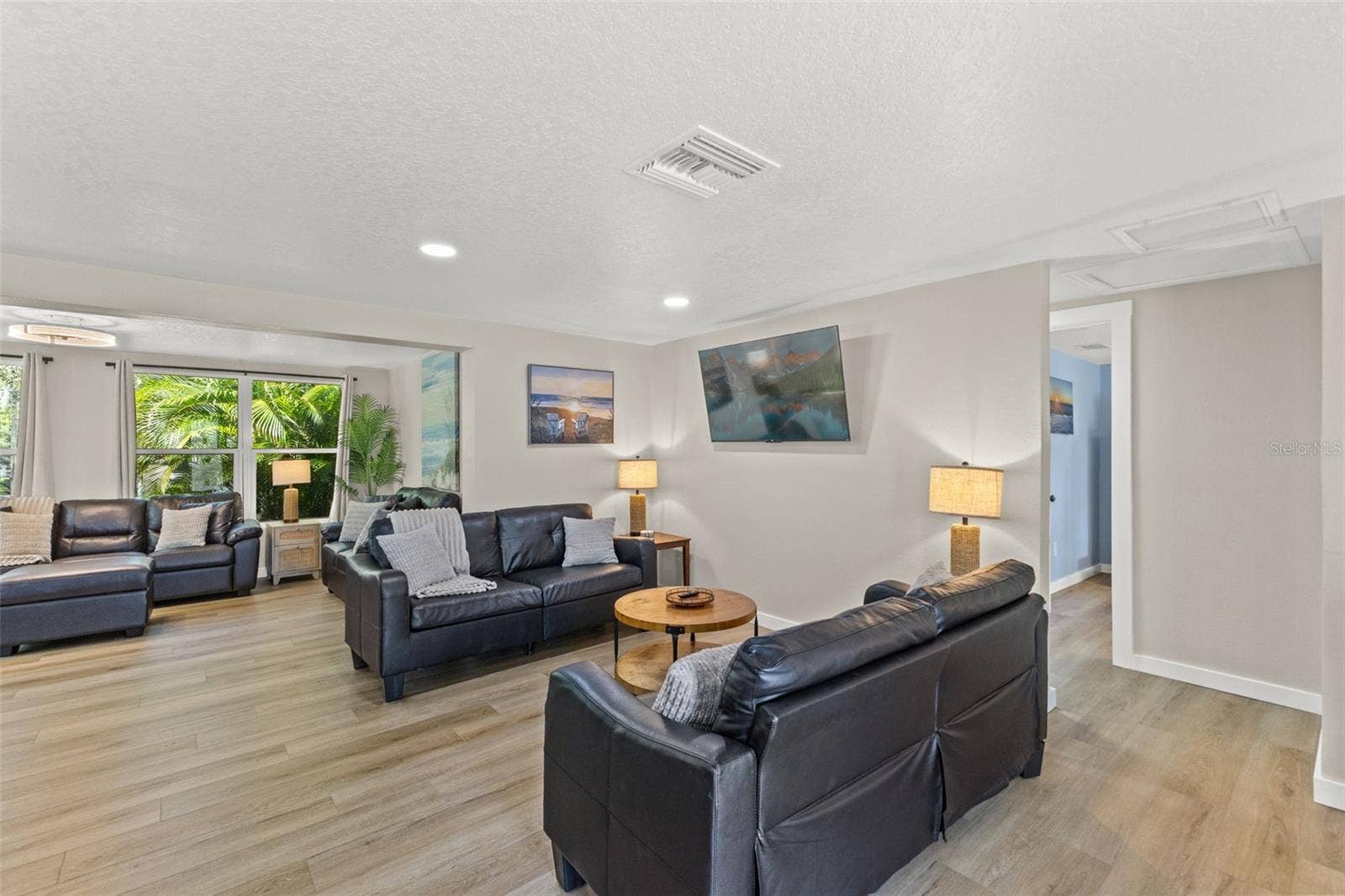 201 SOUTH STREET, Palm Harbor, FL 34683 Spacious living area with luxury vinyl plank flooring, abundant natural light, and an open layout.