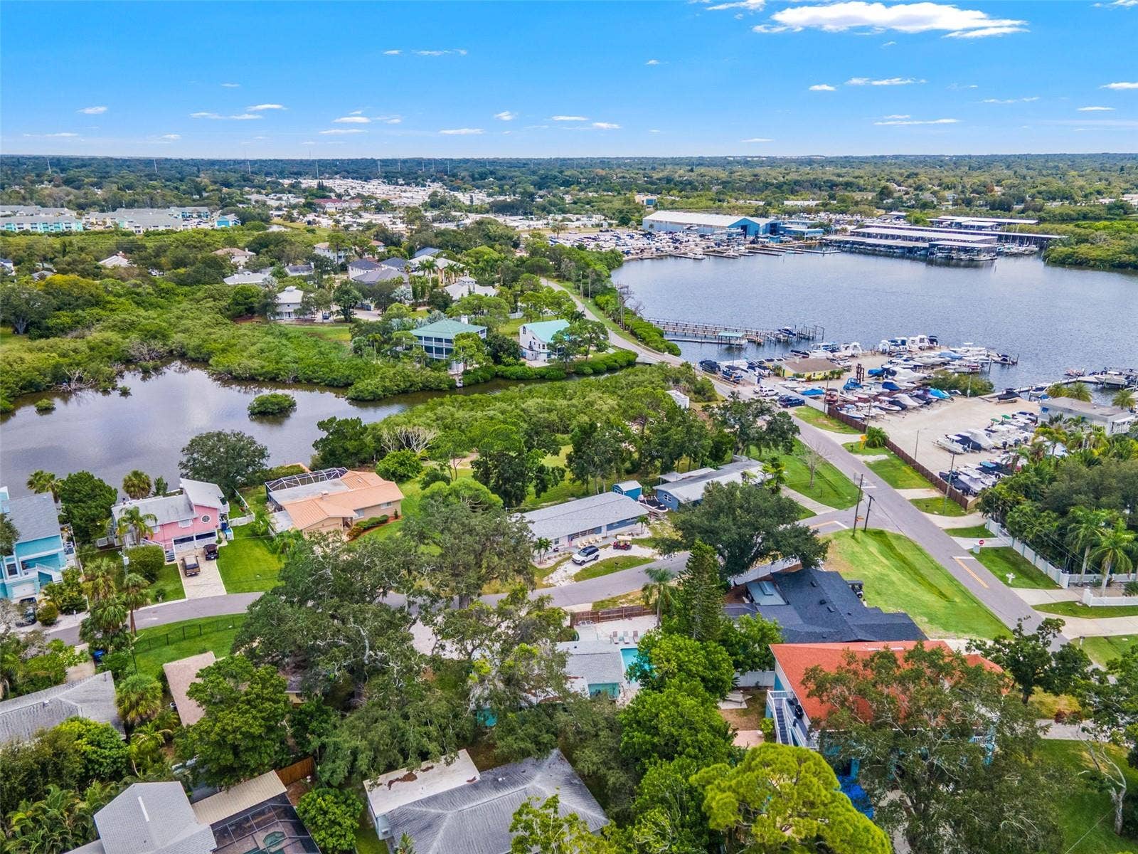 201 SOUTH STREET, Palm Harbor, FL 34683 Aerial view showcasing the homes location in Ozona, surrounded by marinas, waterways, and the areas coastal setting.
