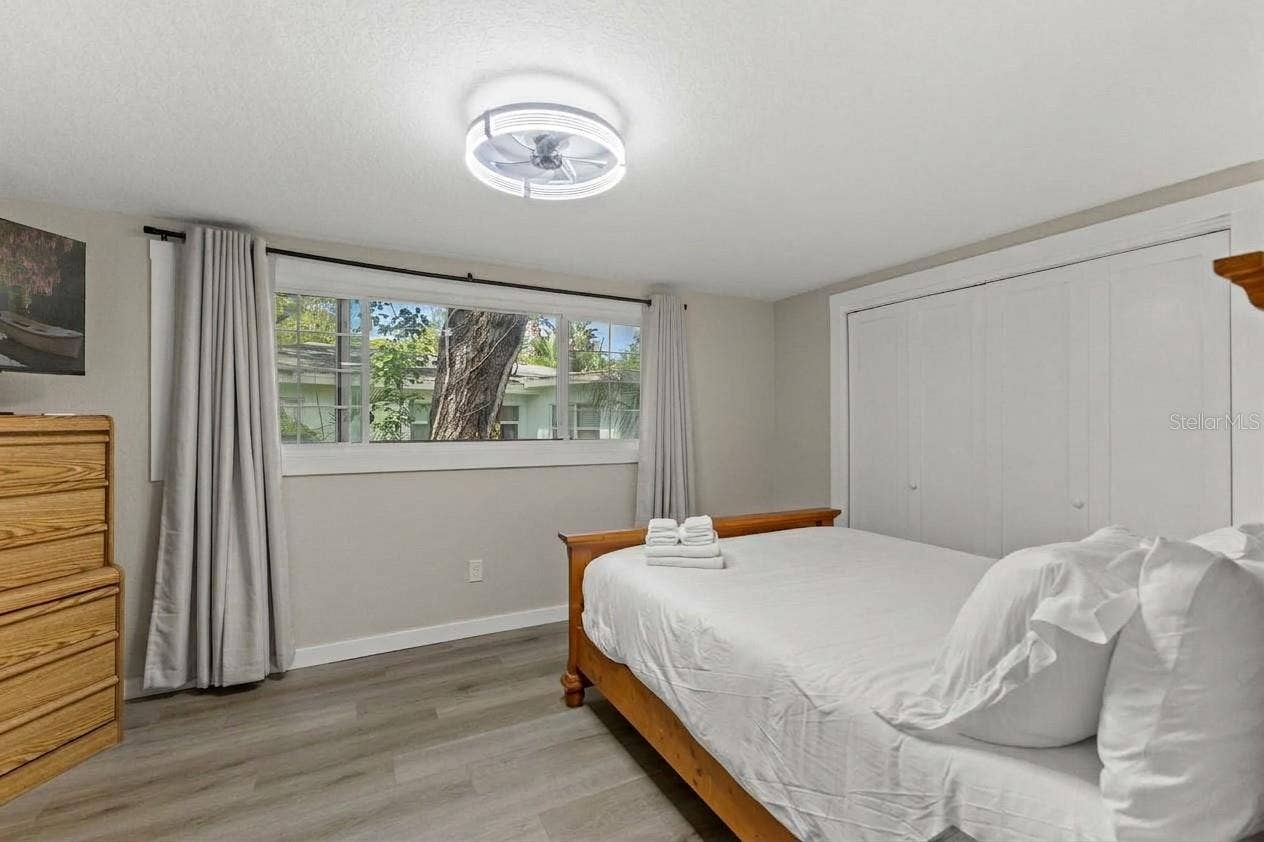 201 SOUTH STREET, Palm Harbor, FL 34683 Spacious third bedroom with LVP flooring, modern ceiling fan, and flexible space for guests, a home office, or both.