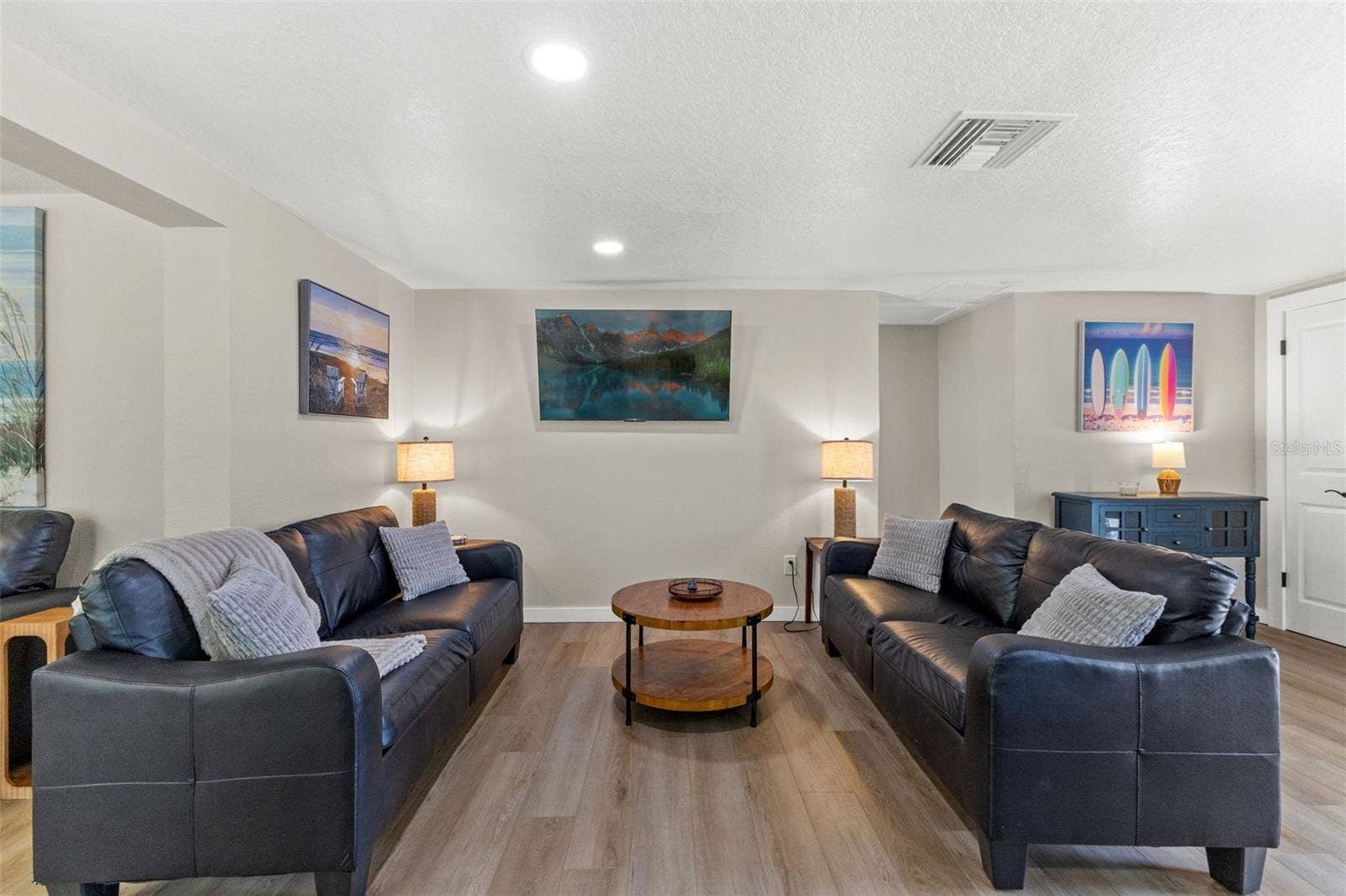 201 SOUTH STREET, Palm Harbor, FL 34683 Spacious main living area with luxury vinyl plank flooring and an open layout that connects easily to the kitchen and dining spaces.