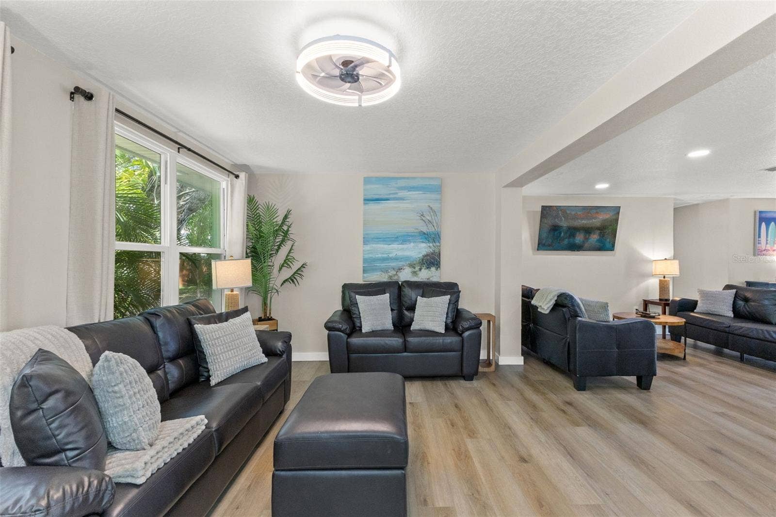 201 SOUTH STREET, Palm Harbor, FL 34683 Large windows bring natural light and tropical views into this spacious living area.