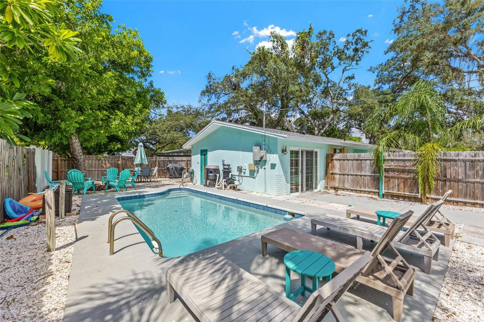 201 SOUTH STREET, Palm Harbor, FL 34683 Private pool and patio create an easy outdoor extension of the home, with mature trees providing a natural backdrop.