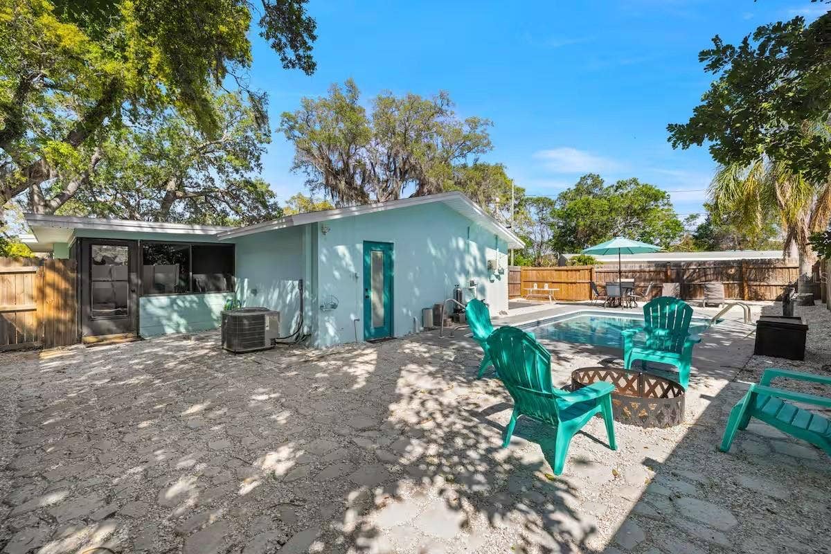 201 SOUTH STREET, Palm Harbor, FL 34683 A fully fenced backyard offers more than just a pool, with a dedicated fire-pit area and plenty of space to gather outdoors.