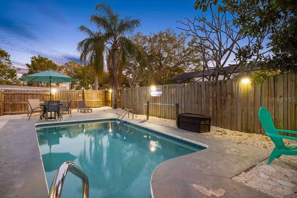 201 SOUTH STREET, Palm Harbor, FL 34683 The private HEATED POOL takes center stage in this fully fenced backyard, with plenty of room to relax, dine, and enjoy Florida evenings outdoors.