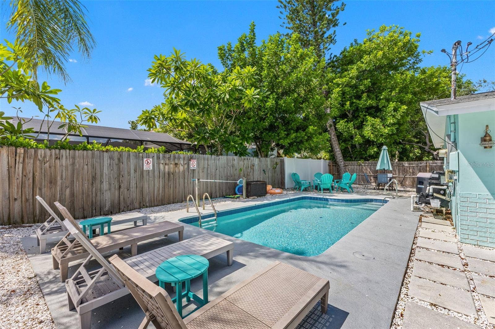 201 SOUTH STREET, Palm Harbor, FL 34683 Your own private Florida retreat with a heated pool, lounging space, and a fully fenced yard.