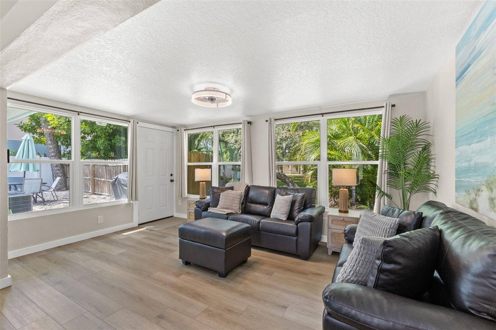 201 SOUTH STREET, Palm Harbor, FL 34683 Multiple windows and direct outdoor access connect this bright living space to the homes outdoor areas.