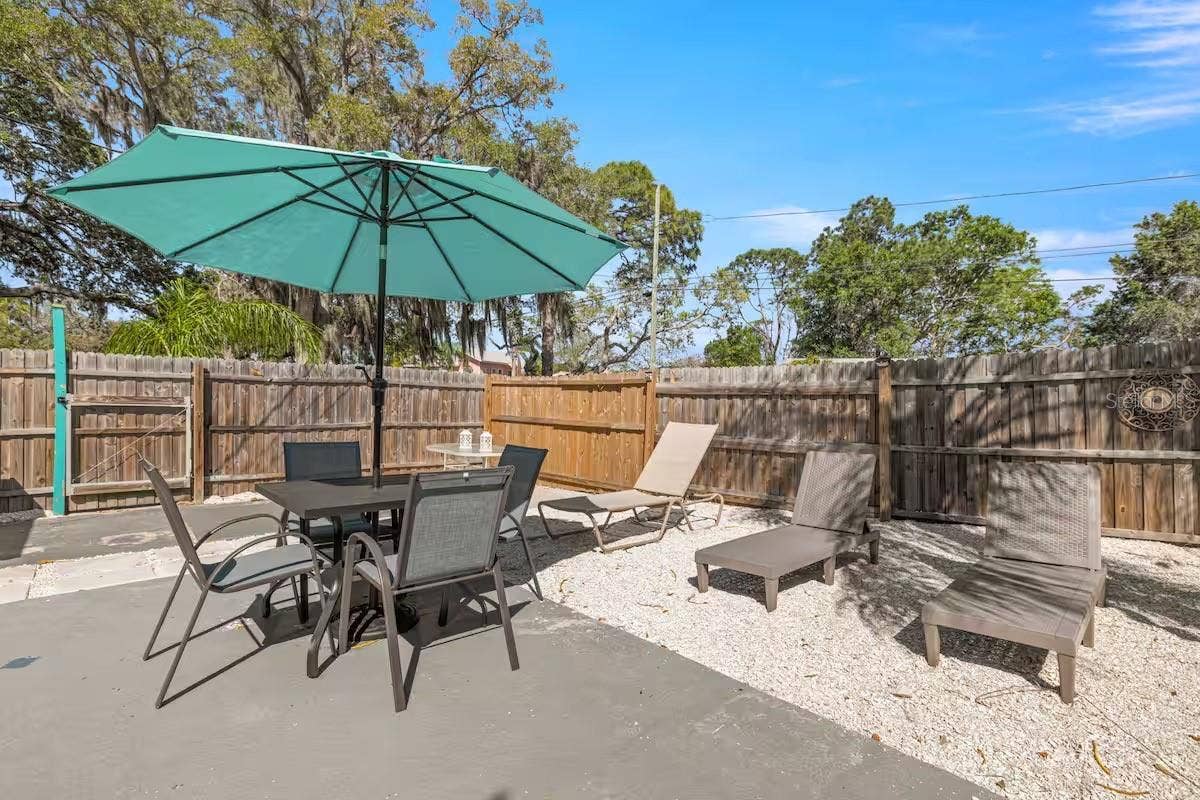 201 SOUTH STREET, Palm Harbor, FL 34683 Multiple outdoor living areas provide space for dining in the shade, lounging poolside, or simply kicking back after a swim.