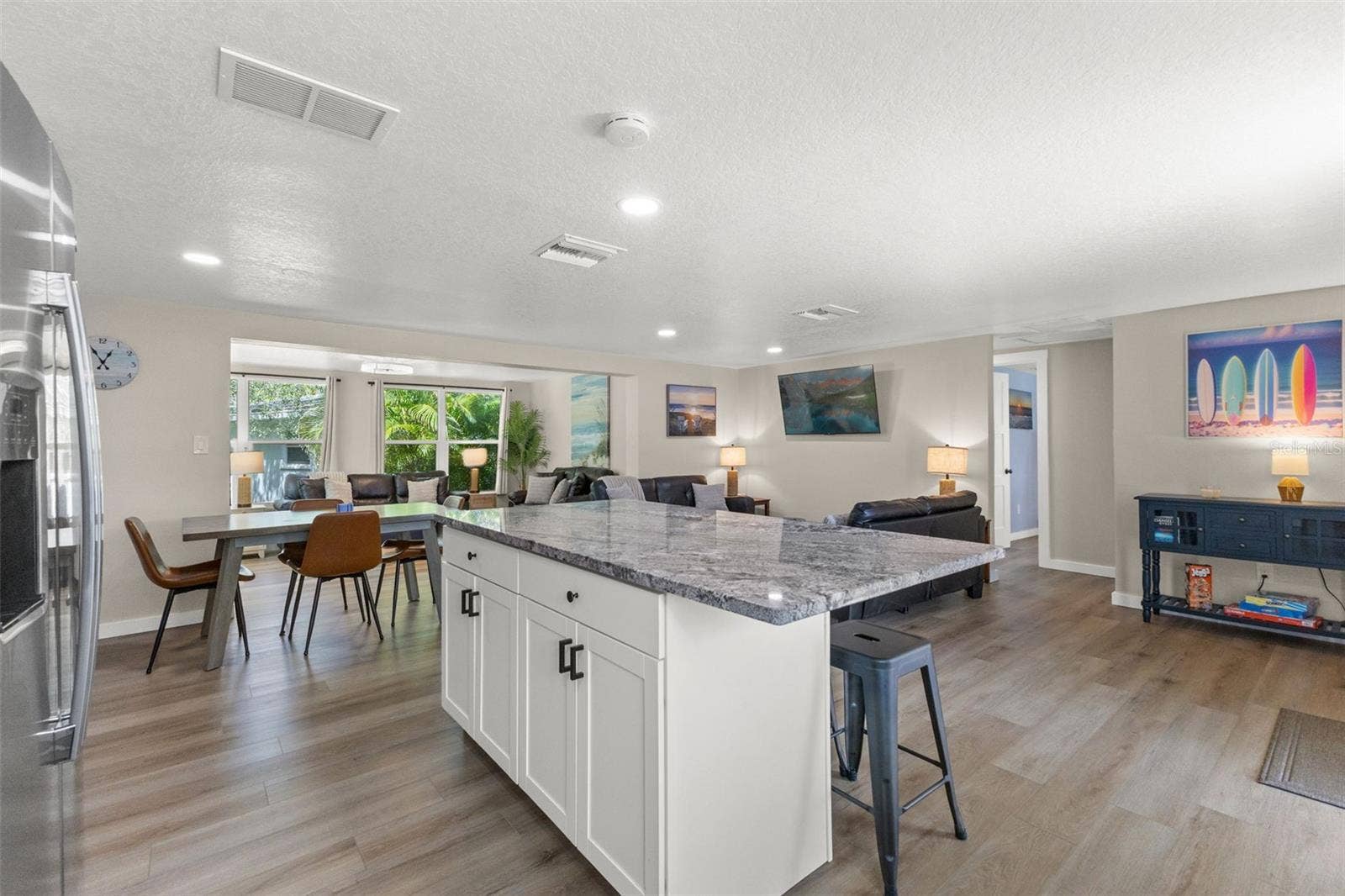 201 SOUTH STREET, Palm Harbor, FL 34683 The large kitchen island anchors the open floor plan, connecting the kitchen to the dining and living areas.