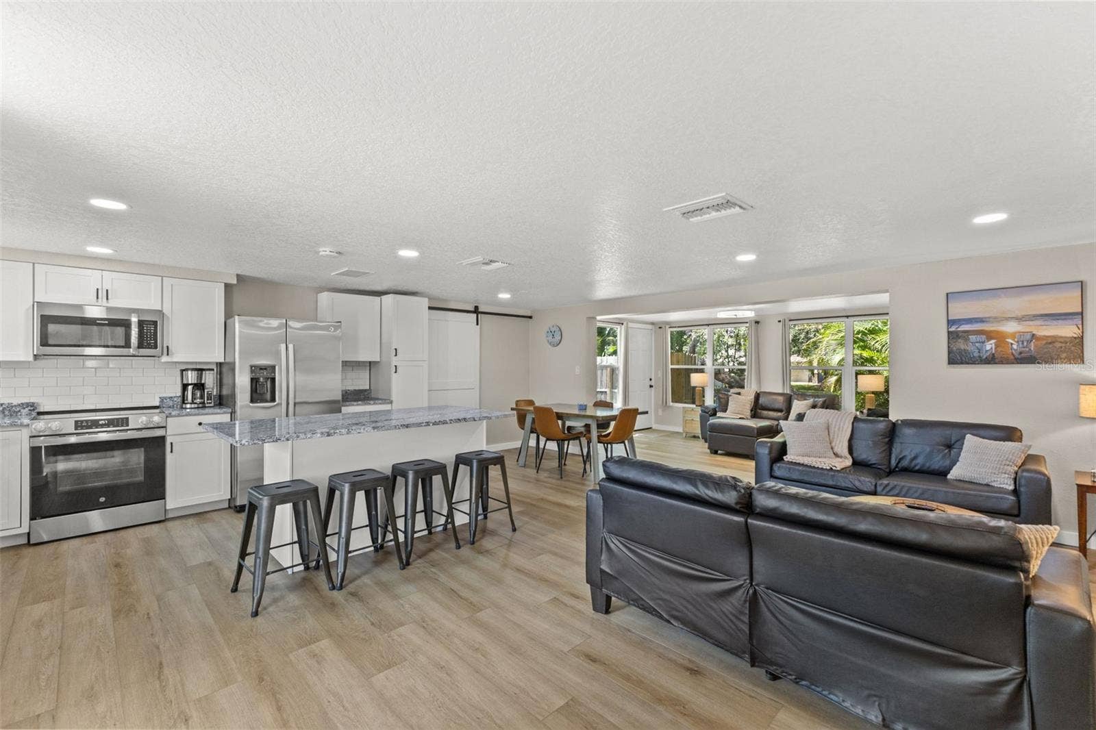 201 SOUTH STREET, Palm Harbor, FL 34683 The renovated kitchen opens to the main living areas and features new cabinetry, granite countertops, stainless steel appliances, and a large gathering island.