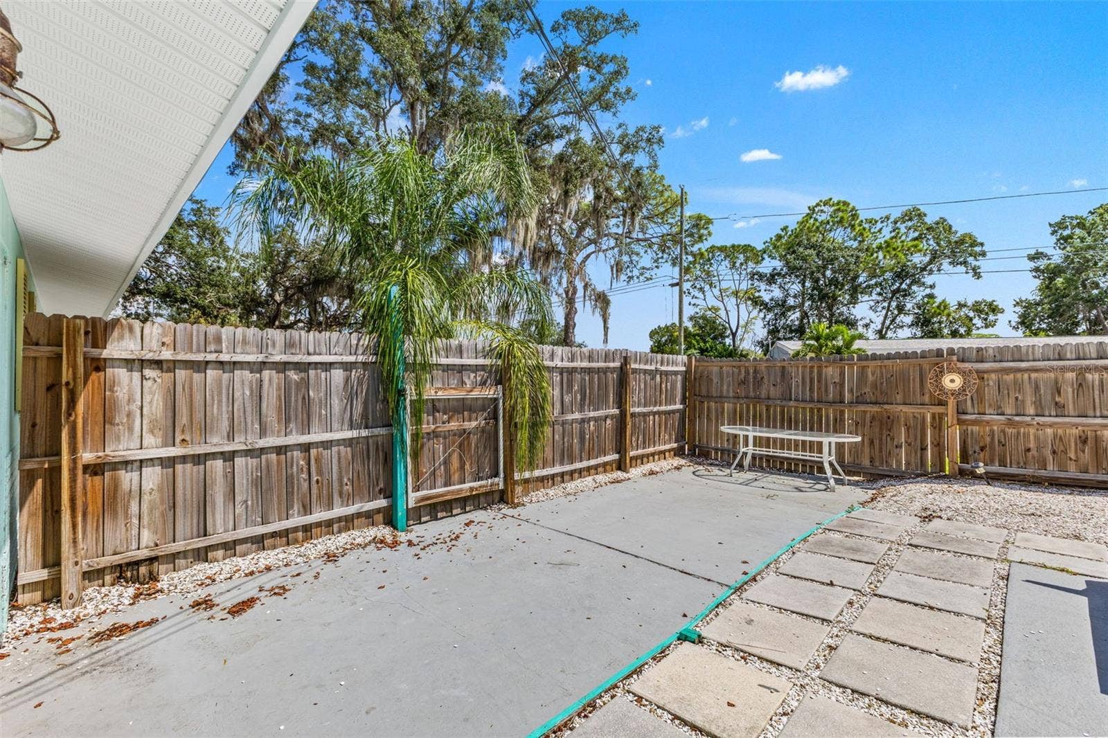 201 SOUTH STREET, Palm Harbor, FL 34683 Additional fenced patio space offers even more room for outdoor dining, grilling, or creating a separate sitting area.