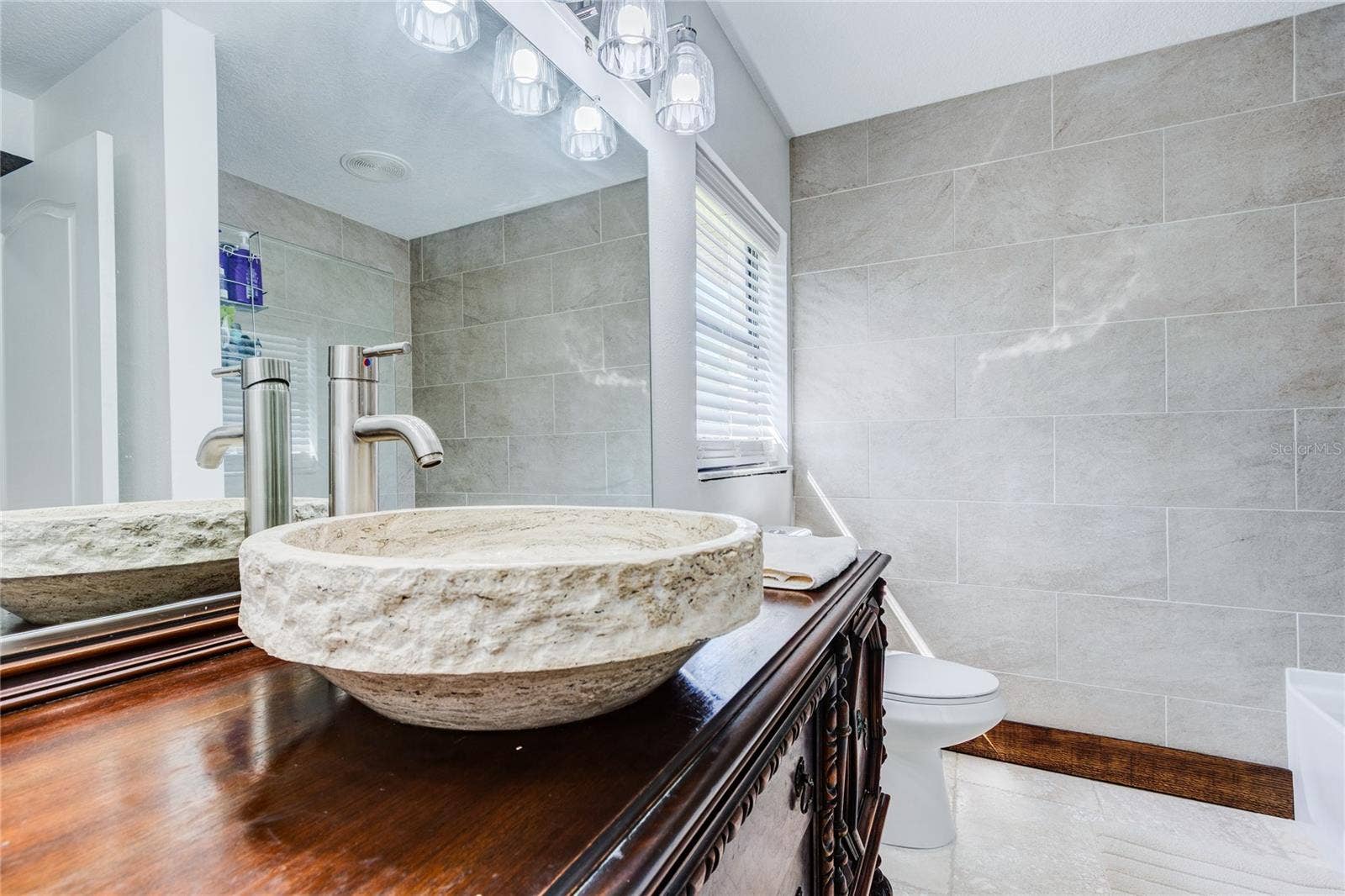 32305 PASCO ROAD, San Antonio, FL 33576 Travertine sink and antique wood vanity!