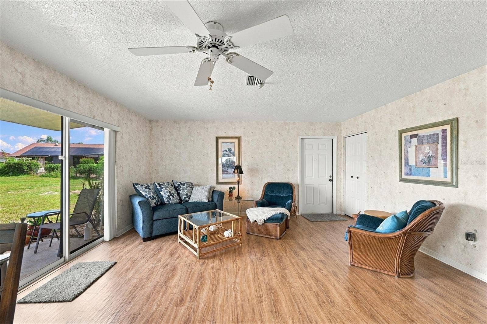 The living room is spacious and open with a full view of the greenbelt and wildlife activity.