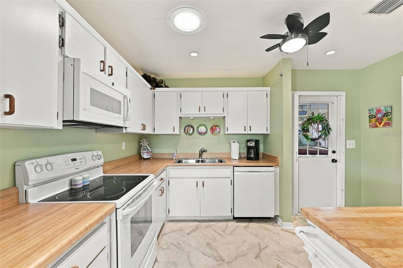 Butcher block counter tops and all appliances are nicely coordinated.  The solar tube allows natural sunshine into the kitchen.
