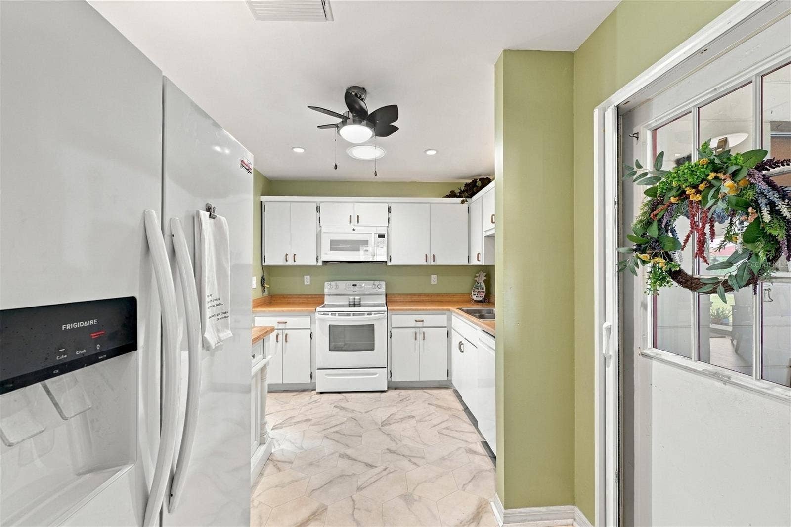 The kitchen is a very nice size and the door to the garage has a screen door attachment, so that you can open the garage door and let the sea breezes blow through the home.