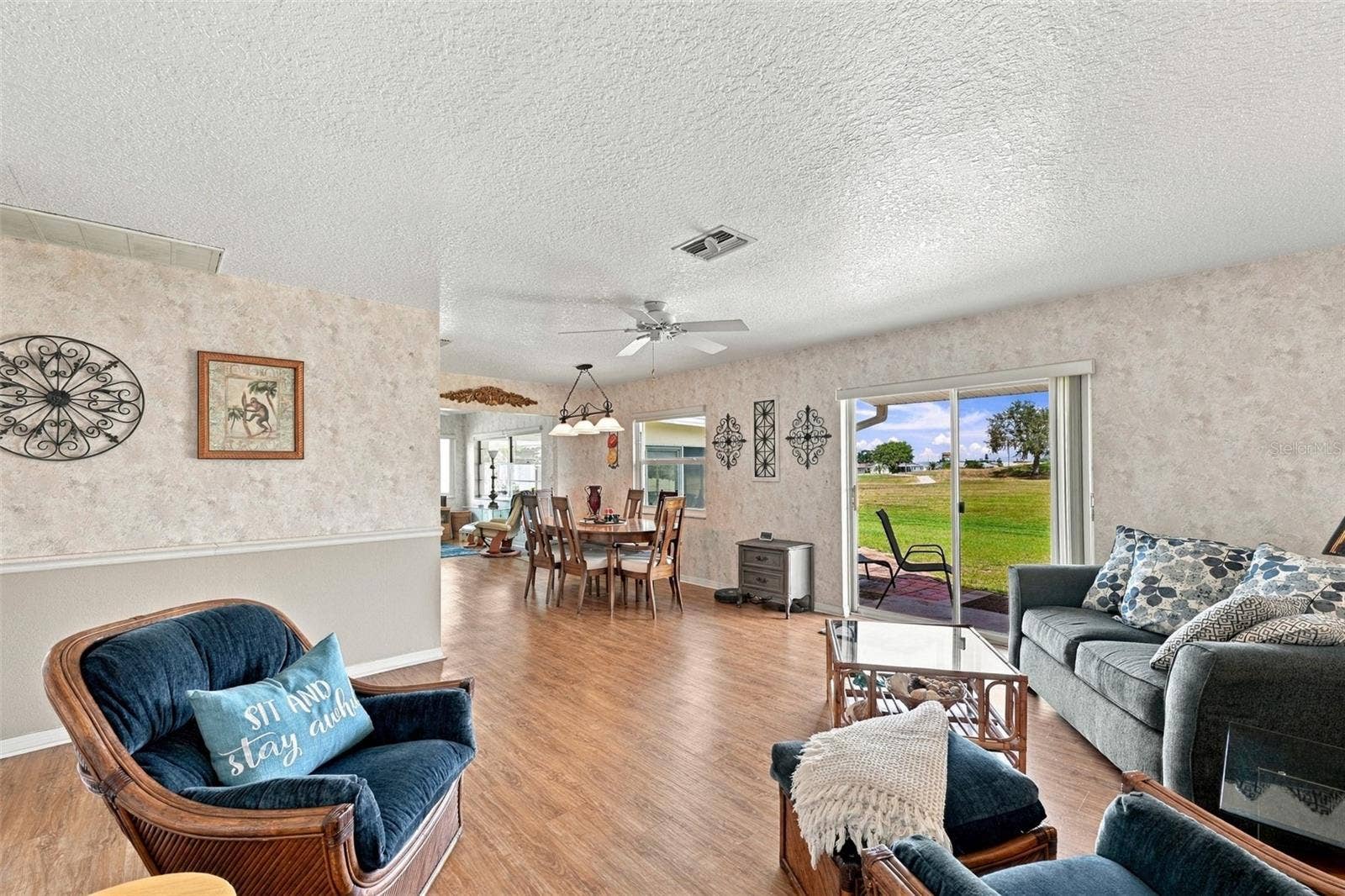As you walk into the home, it is an open floor plan with lots of natural Florida sunshine filtering in through the new impact windows.