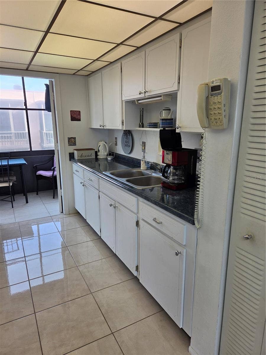 5969 TERRACE PARK DRIVE N, #305, St Petersburg, FL 33709 Access to the screened lanai from the kitchen