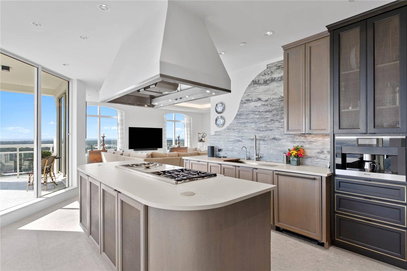 Kitchen island with Wolf gas French Top 6 burner Cooktop and pop up electrical outlets on the island