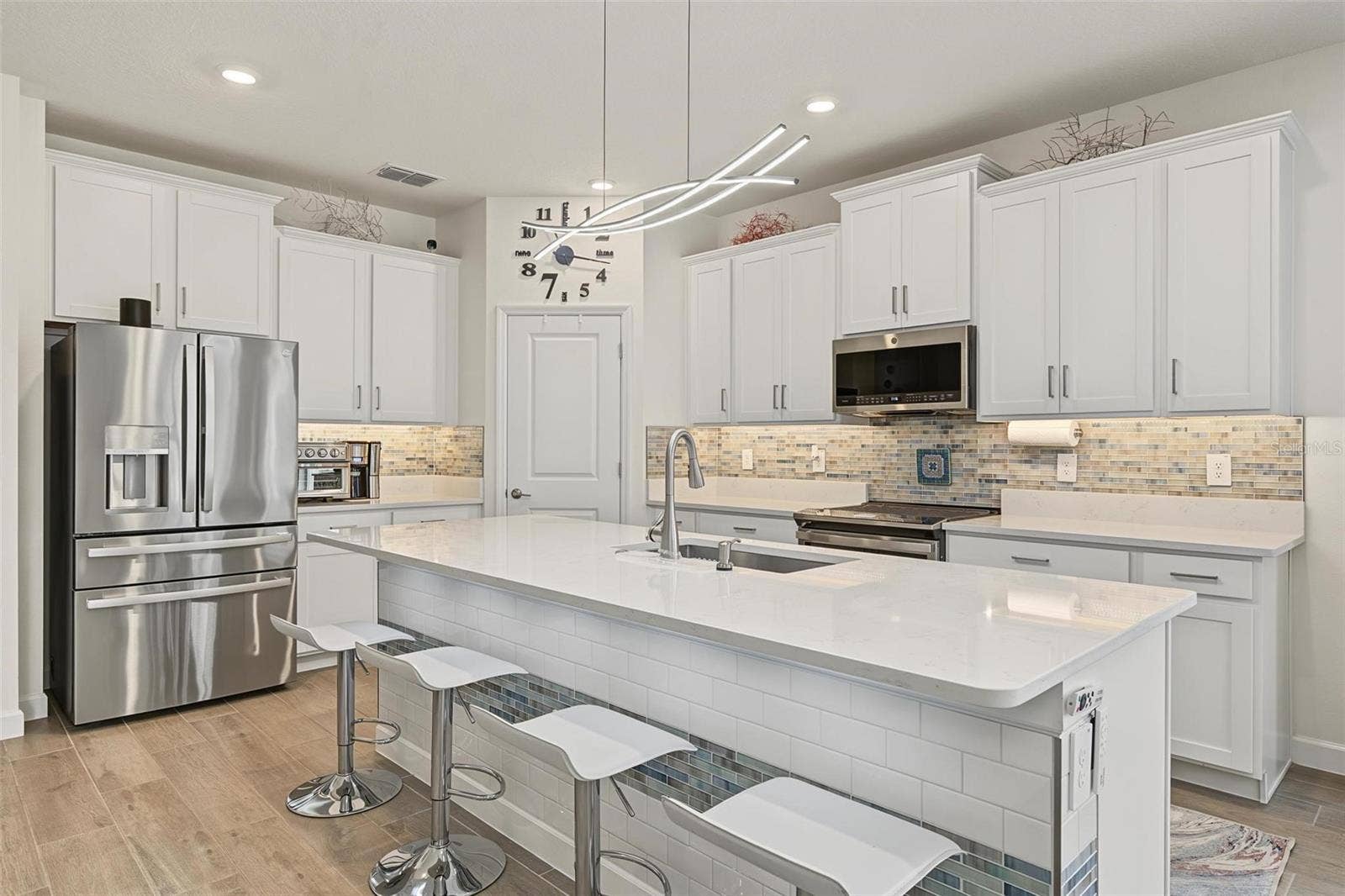upgraded appliances, backsplash and under cabinet lighting