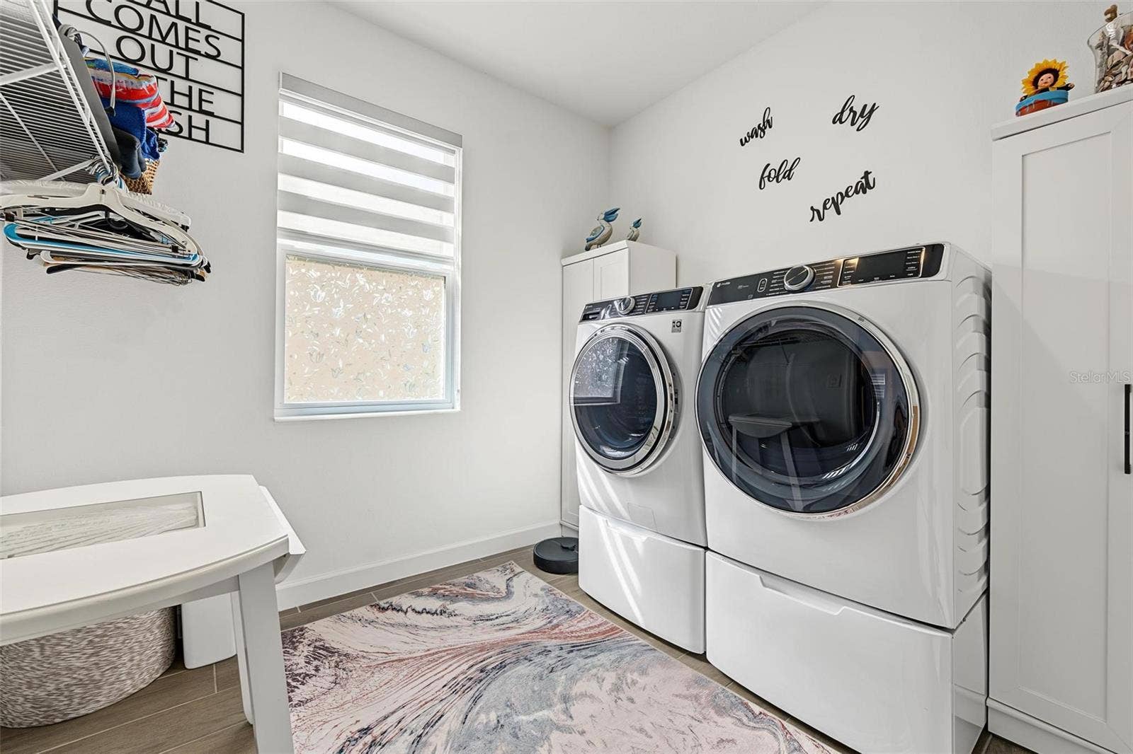 spacious laundry room opens to owners closet