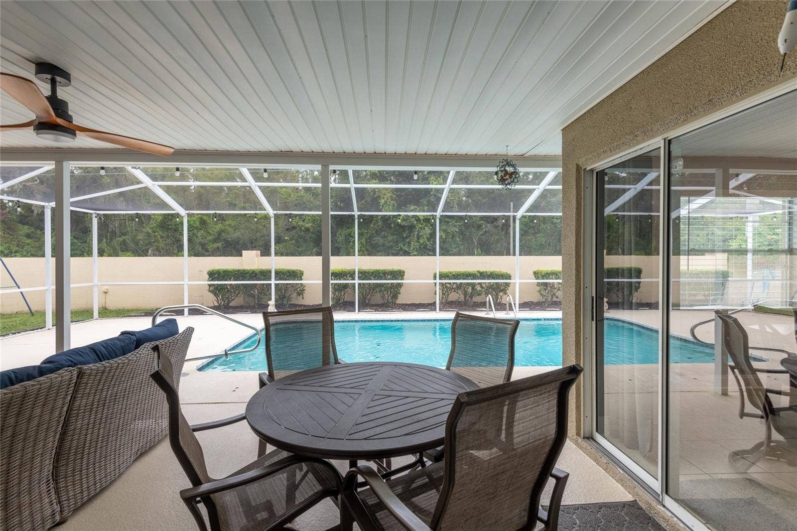 9713 LOMALINDA COURT, New Port Richey, FL 34655 View from great room and the sliders on the right lead to the dinette and kitchen.