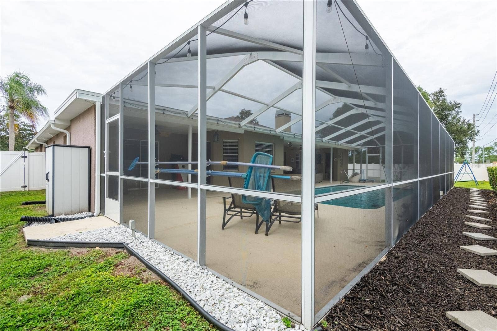 9713 LOMALINDA COURT, New Port Richey, FL 34655 Side yard with a shed.