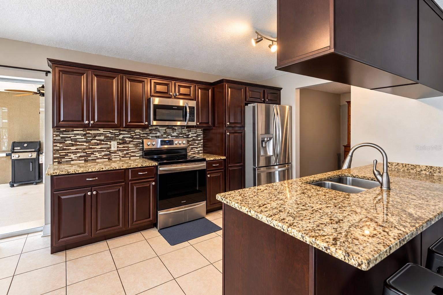 9713 LOMALINDA COURT, New Port Richey, FL 34655 The sliding glass door recesses for grilling and eating outside.