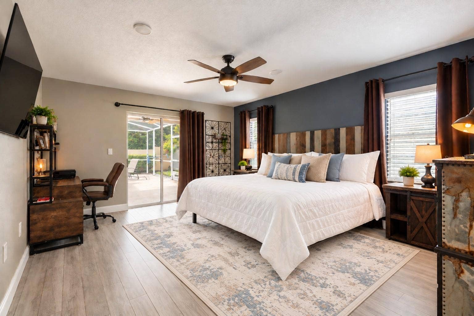 9713 LOMALINDA COURT, New Port Richey, FL 34655 Spacious primary suite with sliders leading to a private covered patio area.