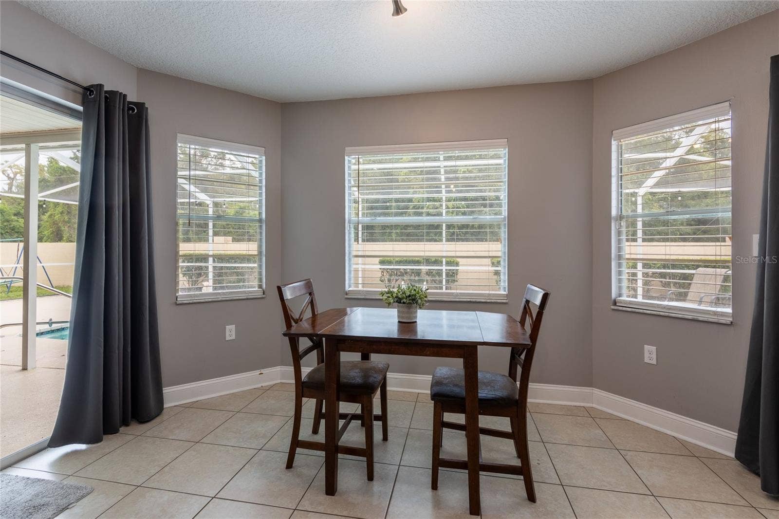 9713 LOMALINDA COURT, New Port Richey, FL 34655 Dinette area with two sliders on each side of this area.