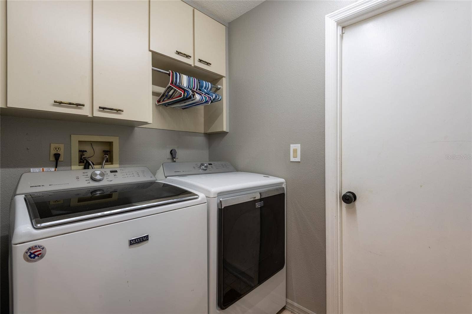 9713 LOMALINDA COURT, New Port Richey, FL 34655 Laundry room with storage cabinets that lead to the garage.